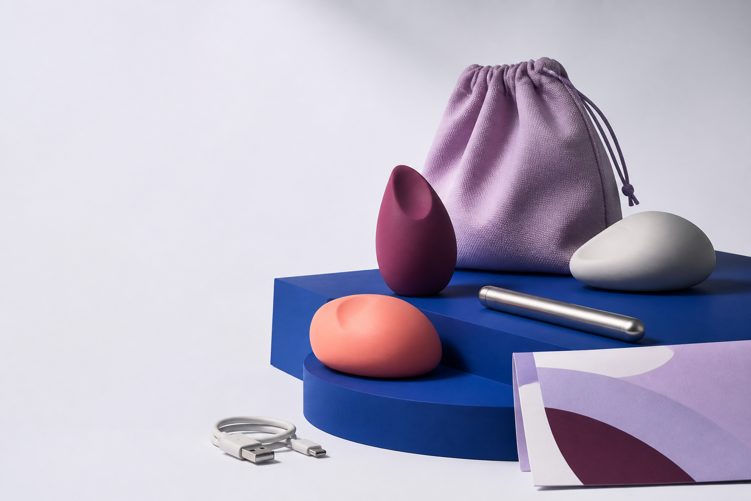 Abstract self-care objects arranged on a cobalt studio platform